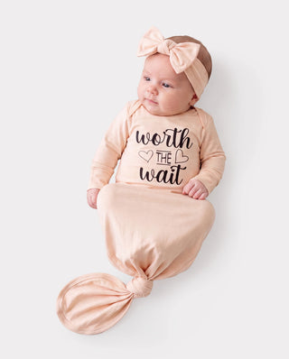 A bamboo infant gown with a matching headband, the kind of newborn set a hat usually arrives with