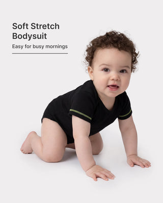 Three-pack of lyocell baby bodysuits in solid colours, the plain base layers worn under everything from six months