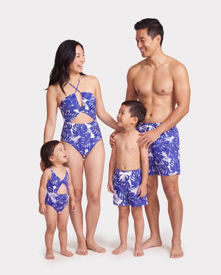 Family matching swim trunks and one-piece in a tropical leaf print, the coverage level that does more than any rating