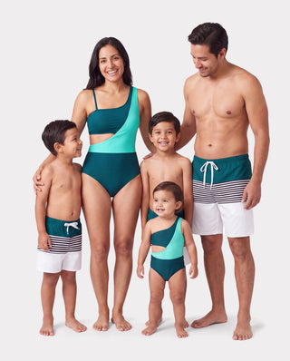 A colourblock one-piece swimsuit laid flat, showing the shoulder-to-shoulder loop that torso length has to fit