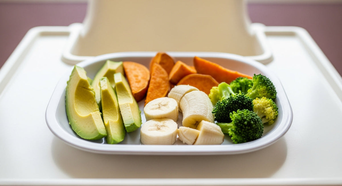 BLW first foods guide colorful spread of avocado spears, sweet potato wedges and banana strips for baby-led weaning