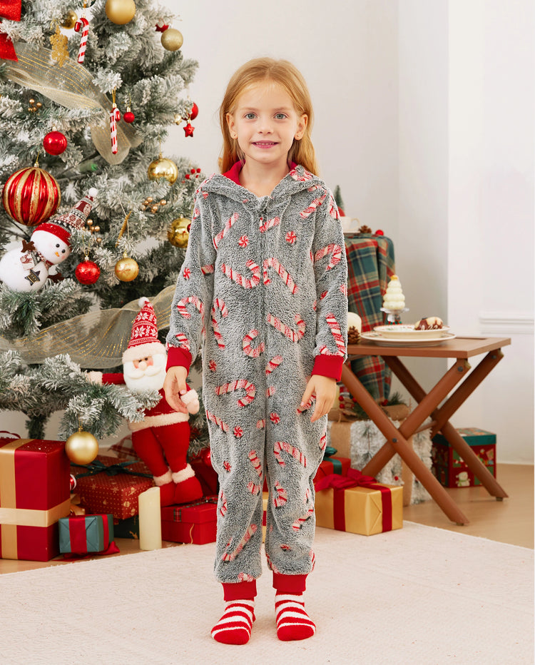 Pijamas de una pieza a juego con trajes navideños, estampado de bastón de caramelo (brillan en la oscuridad) y calcetines navideños negros.