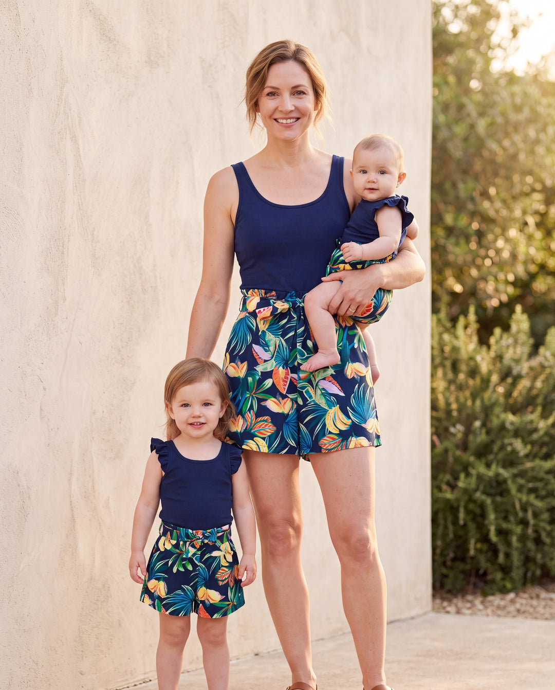 Mommy-and-Me ärmelloses Romper-Set mit tropischem Blattprint und Shorts mit Gürtel – Matching-Set in Dunkelblau.
