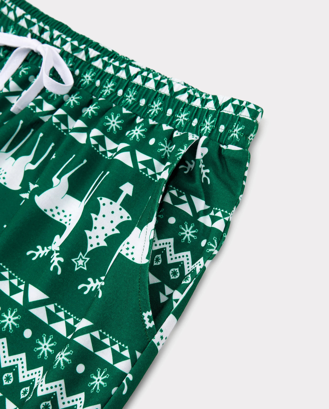 Conjunto de pijama familiar navideño con renos que brillan en la oscuridad, pantalones con estampado completo y calcetines navideños de color verde negruzco.