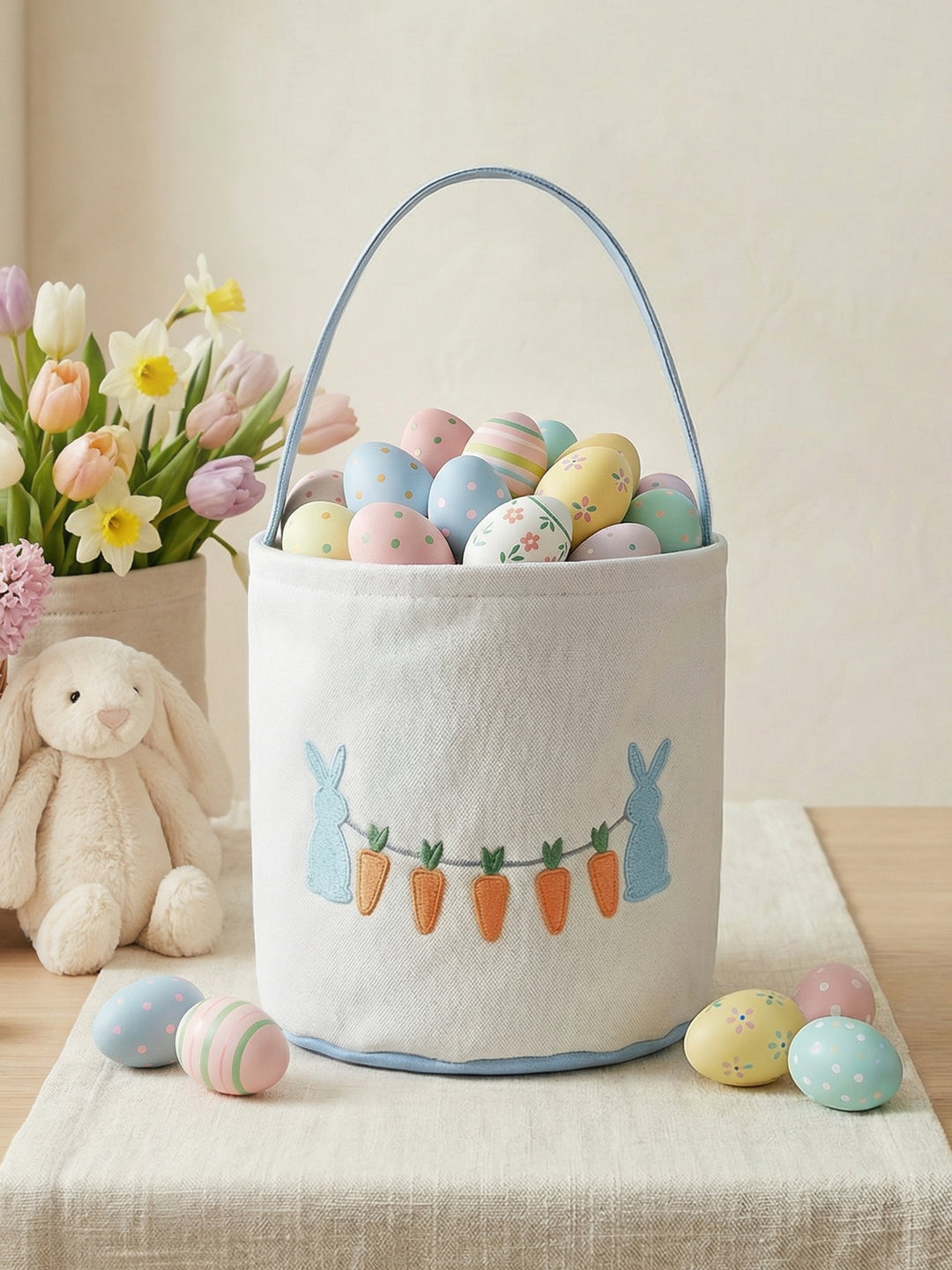 Easter basket with colorful eggs, flowers, and a plush bunny on a light background