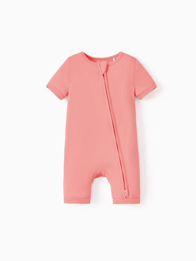 Snug-fitting bamboo baby footed onesie with two-way zipper and anti-slip grips, pink.