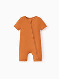 Snug-fitting bamboo baby footed onesie with two-way zipper and anti-slip grips, orange.