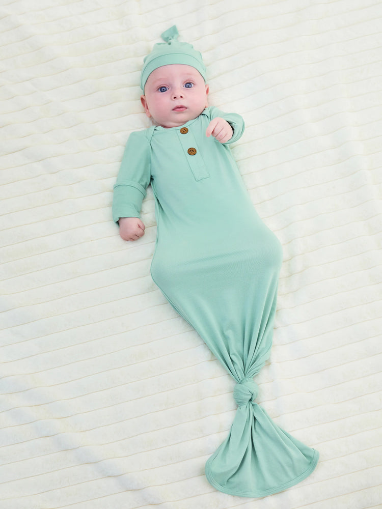 Bamboo infant sleeping gown with matching hat, light green.