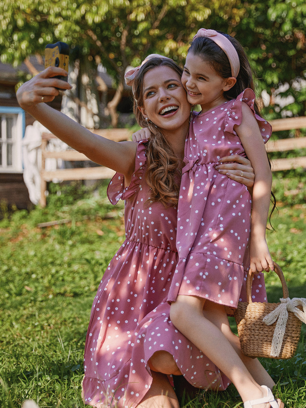 Mom in a pink polka dot cross-wrap V-neck flutter sleeve dress - Mother's Day brunch dress from Patpat